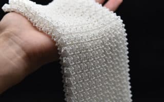 Chain mail-like material transforms from flexible to rigid upon impact