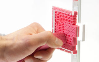 Metamaterial mechanisms made from a single piece of plastic