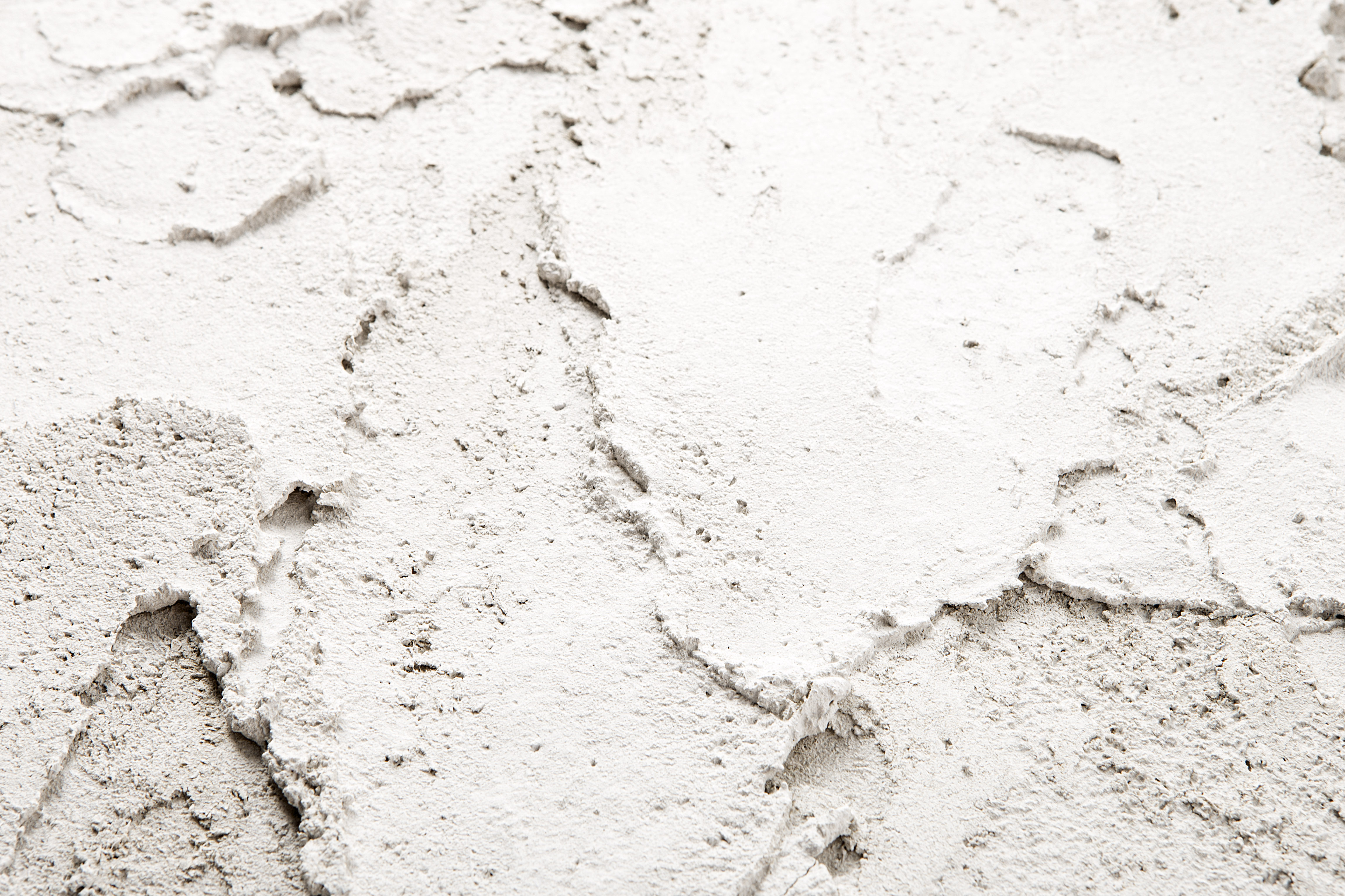 Worker installing thermal insulation on industrial pipes