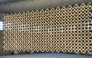 A woven lighting structure made of birch wood